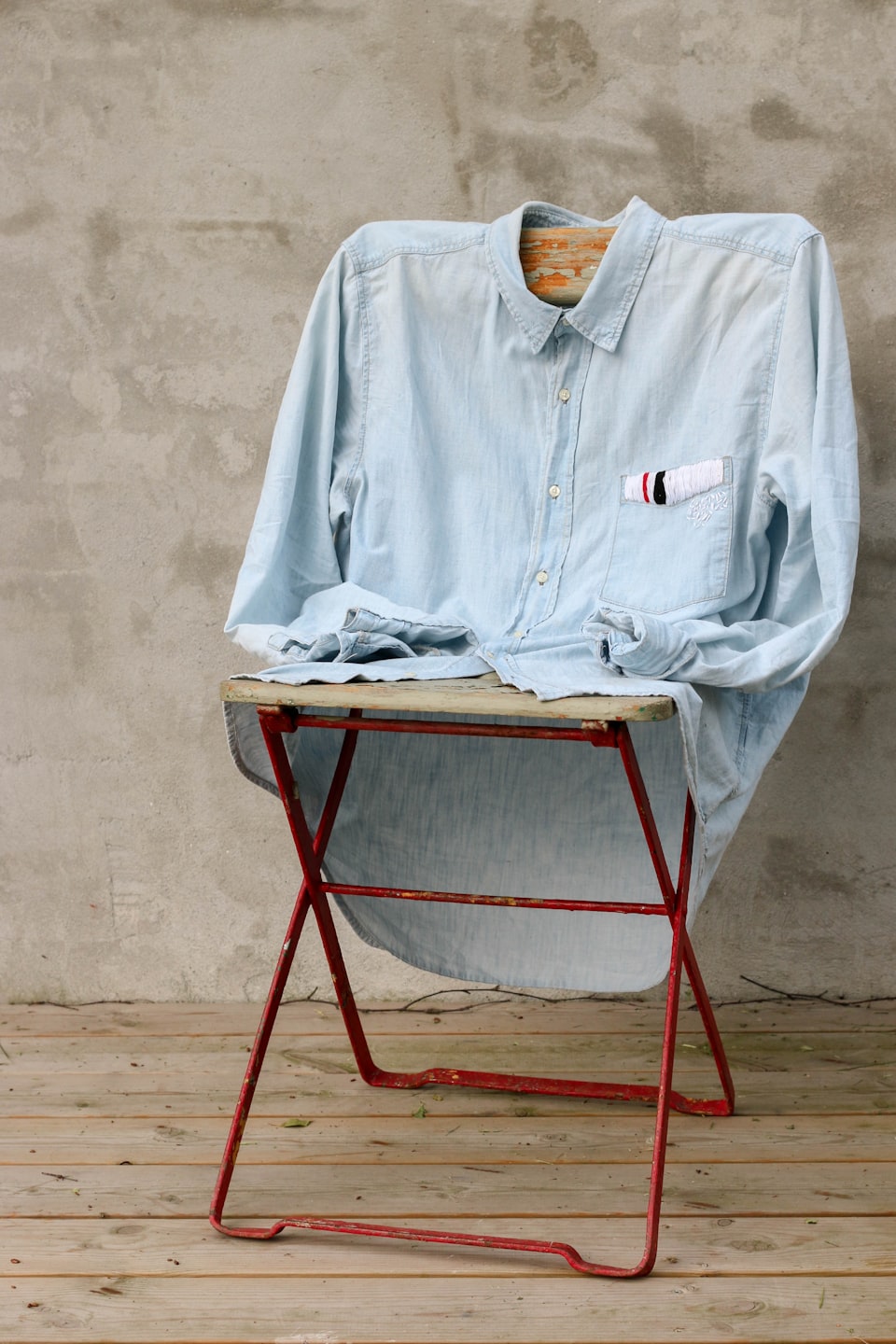 A dress hem over wet grass with fashion tape nearby